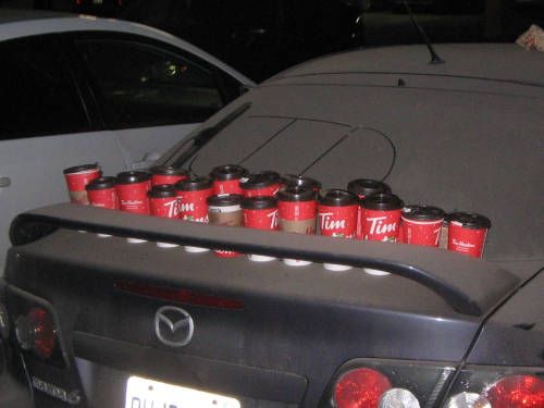 [Dusty car covered with Tim Hortons cups]
