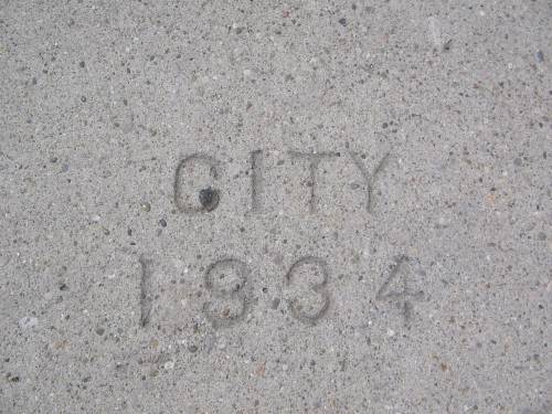 [City 1934 sidewalk stamp]
